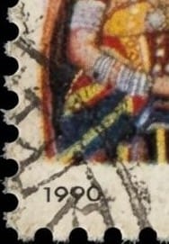 Macro detail of the 1990 Charminar stamp's bottom-left corner showing perforation teeth, the 1990 date, brown foxing spots and cancellation marks