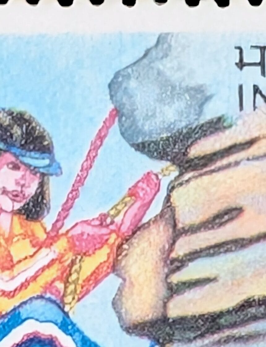 Macro detail of the 1986 Children's Day stamp showing the pink and gold ropes ending in loose tips above the rock