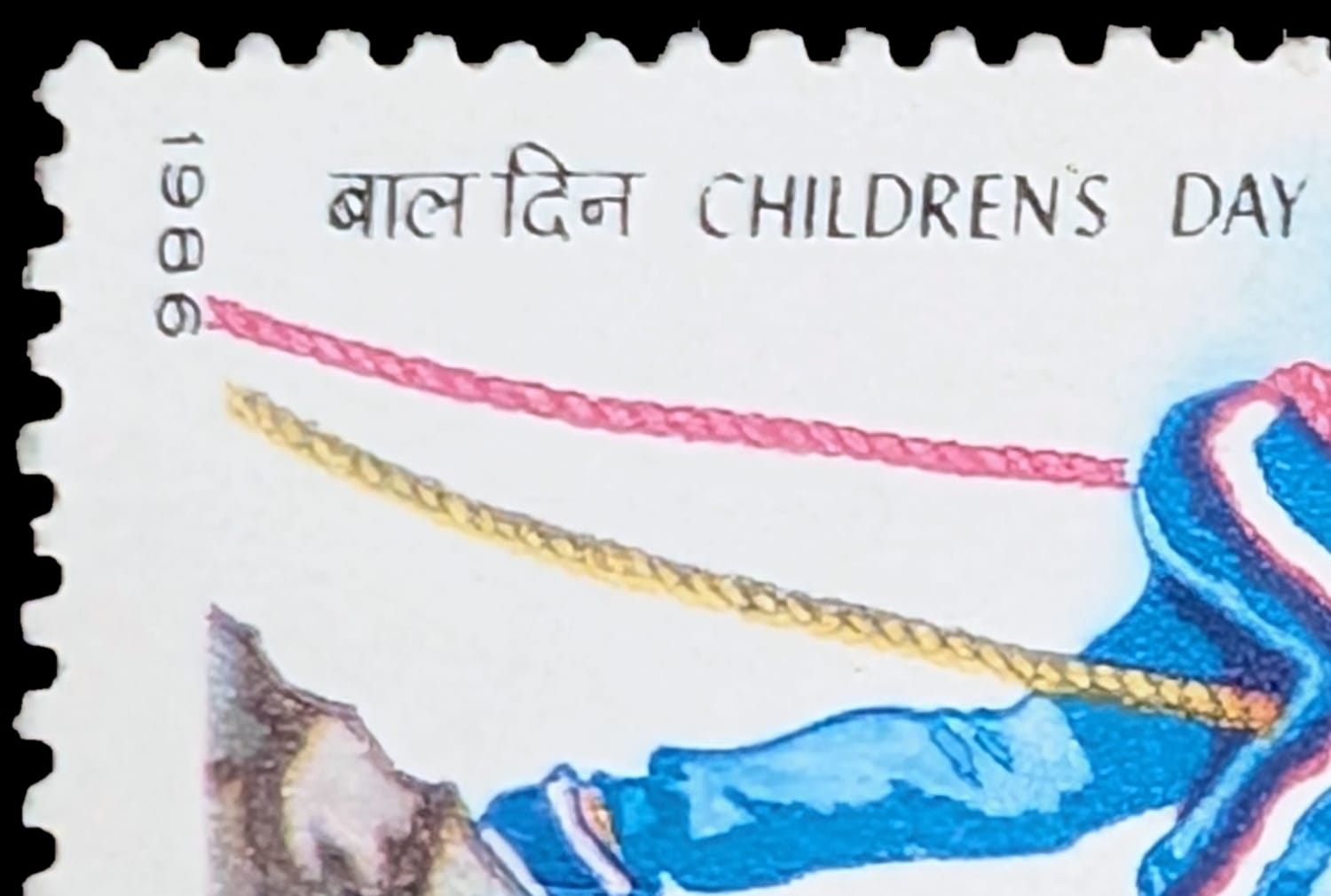 Macro detail of the top left corner showing the year 1986 set vertically and the bilingual Children's Day line above the drawing