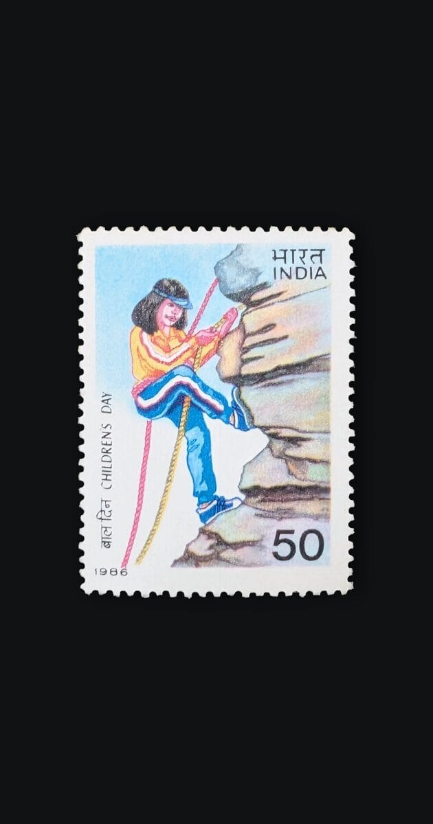 The 1986 Children's Day stamp of India, 50 paise, showing a young climber on a rock face against a pale blue sky