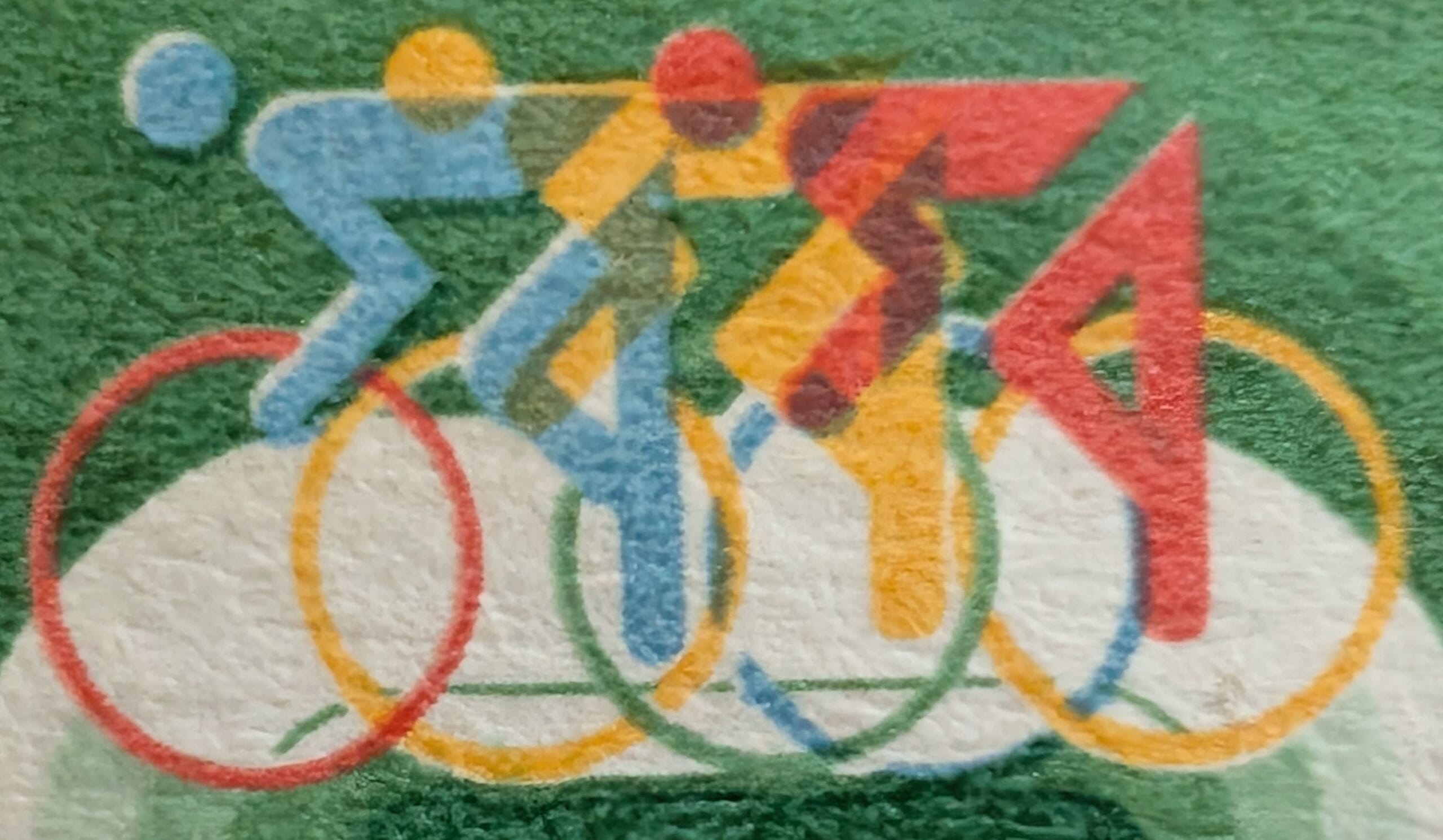 Macro of three overlapping cyclist pictograms in blue, yellow and red racing across interlocking coloured rings on the 1982 India Asian Games stamp