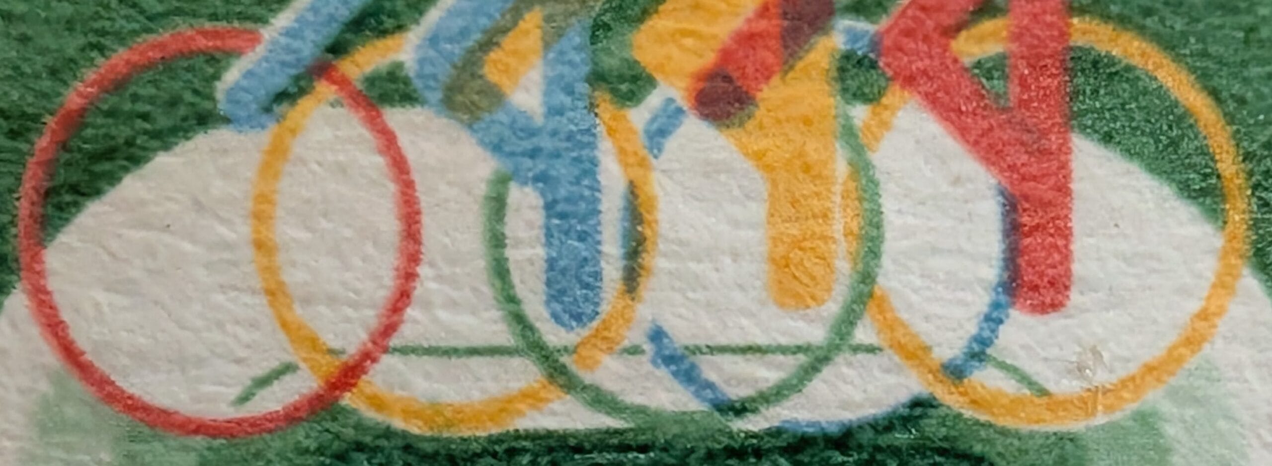 Macro of the five interlocking coloured rings beneath the cyclists on the 1982 India IX Asian Games stamp