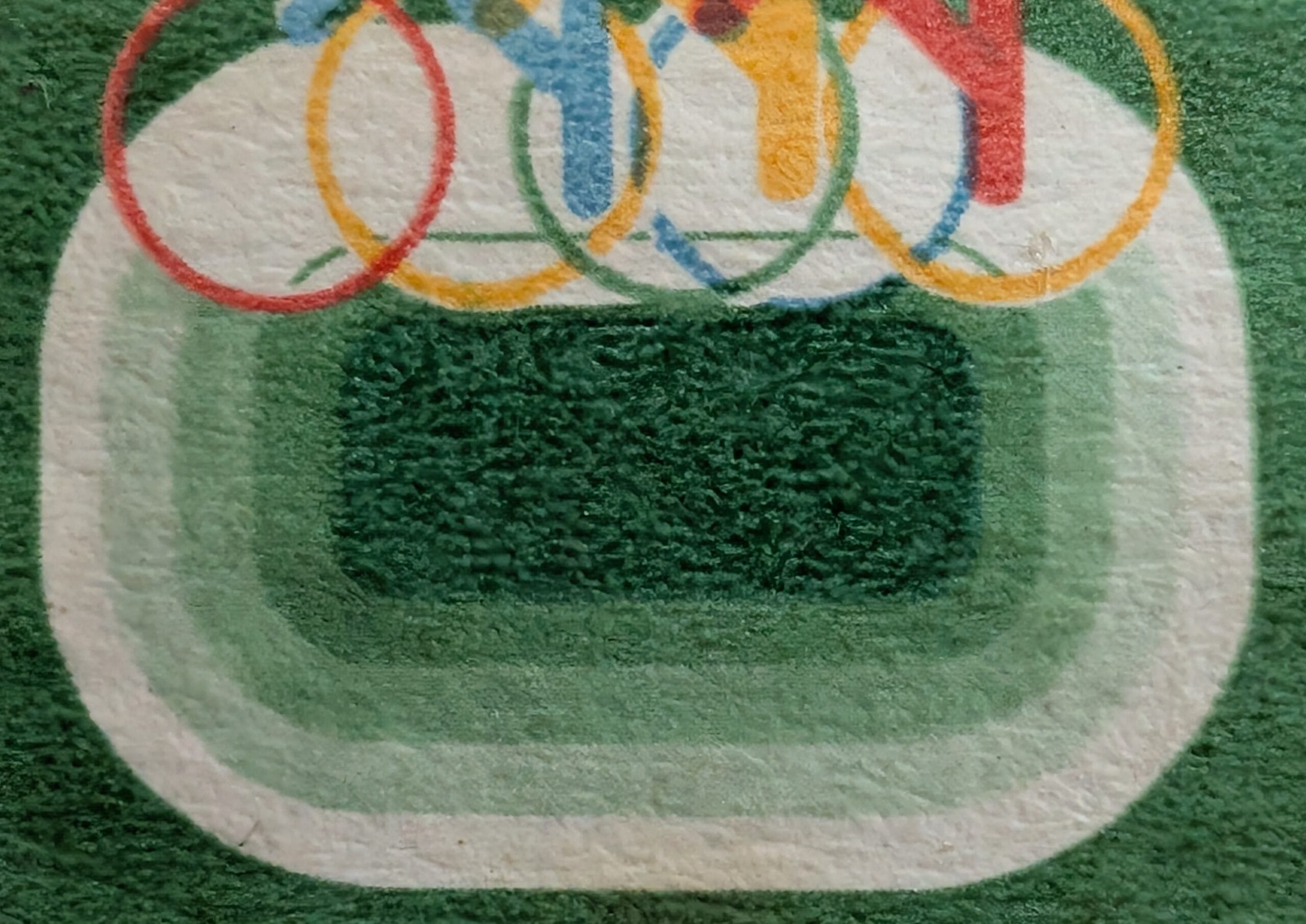 Macro of the green stadium bowl rendered in concentric bands below the cyclists on the 1982 India Asian Games stamp