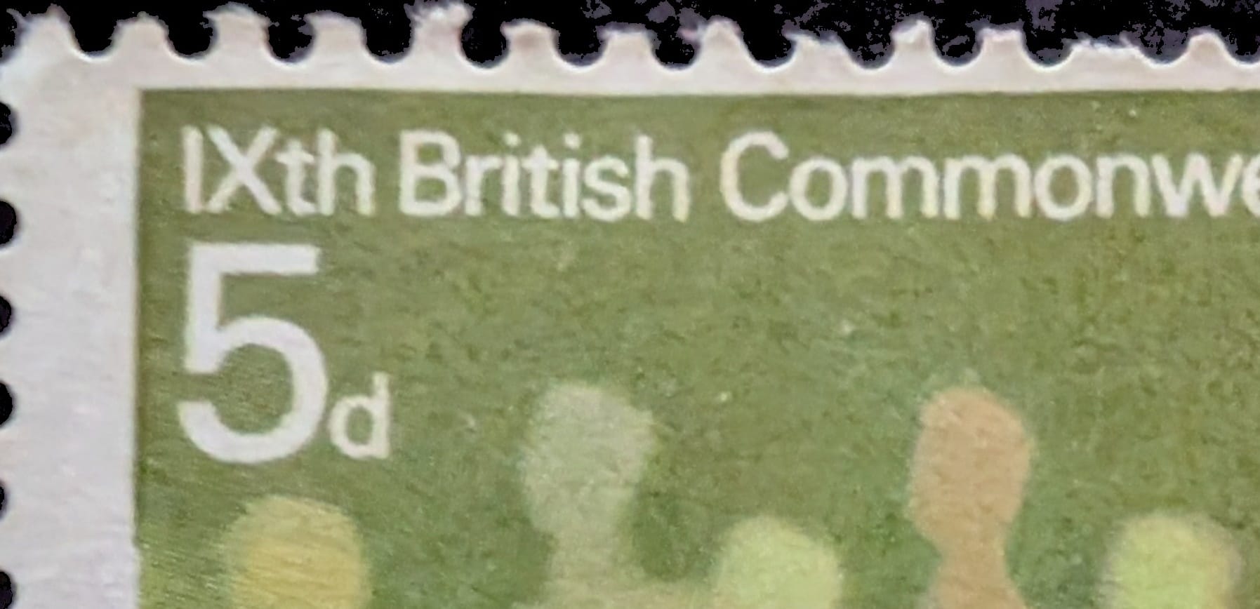 Macro of the top-left corner of the 1970 Commonwealth Games stamp showing the crisp white 5d value and the title IXth British Commonwealth against the green ground