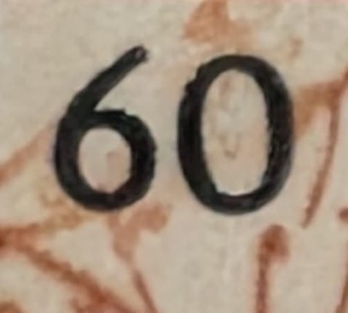 Macro close-up of the 60 paise denomination on the lower portion of the World Philatelic Exhibition 1989 stamp, showing typography and print rendering quality