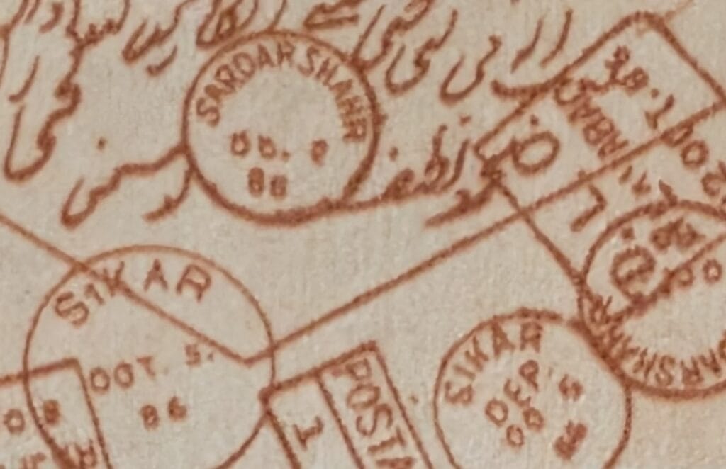 Close-up macro photograph of overlapping D.L.O Dead Letter Office cancellation markings on the World Philatelic Exhibition 1989 stamp, showing inking density variation and hand-stamp impressions