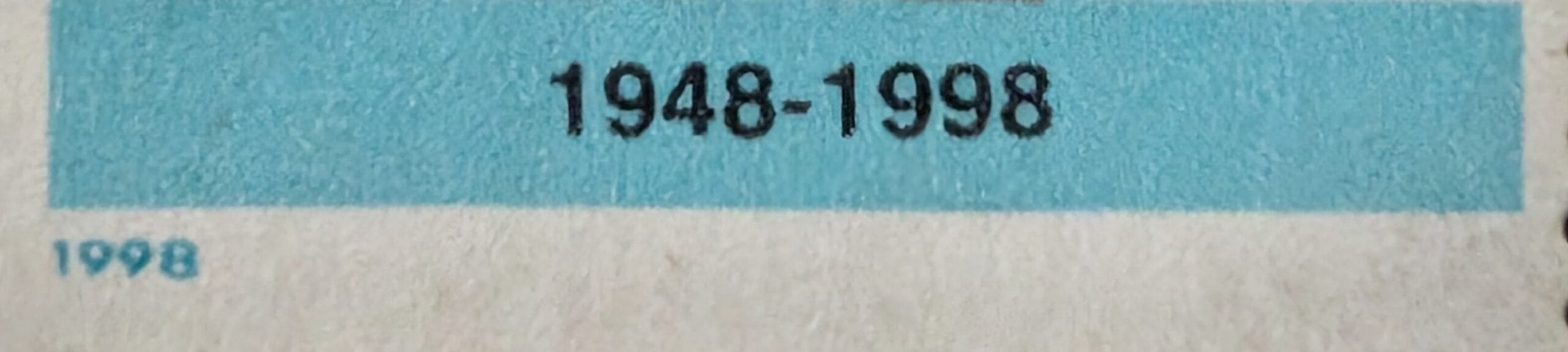 Macro of the teal band reading 1948-1998 at the foot of the 1998 India Universal Declaration of Human Rights stamp