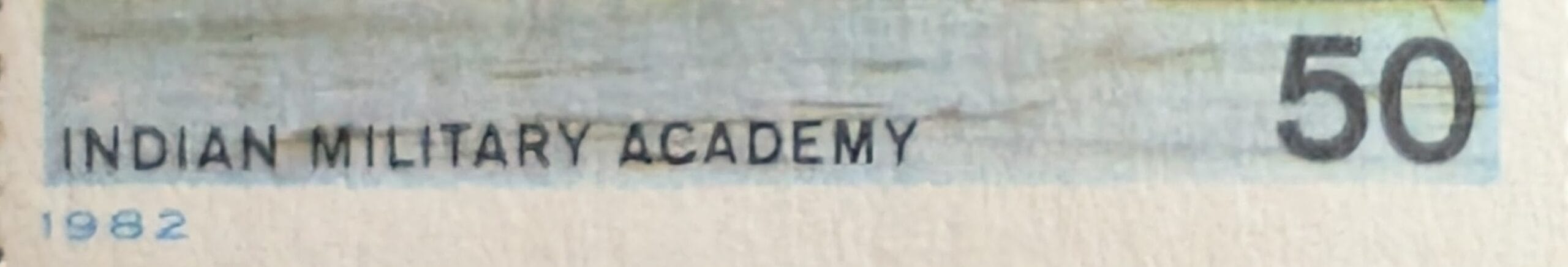 Macro of the lower caption band reading Indian Military Academy with the year 1982 and the fifty paise denomination on the 1982 stamp