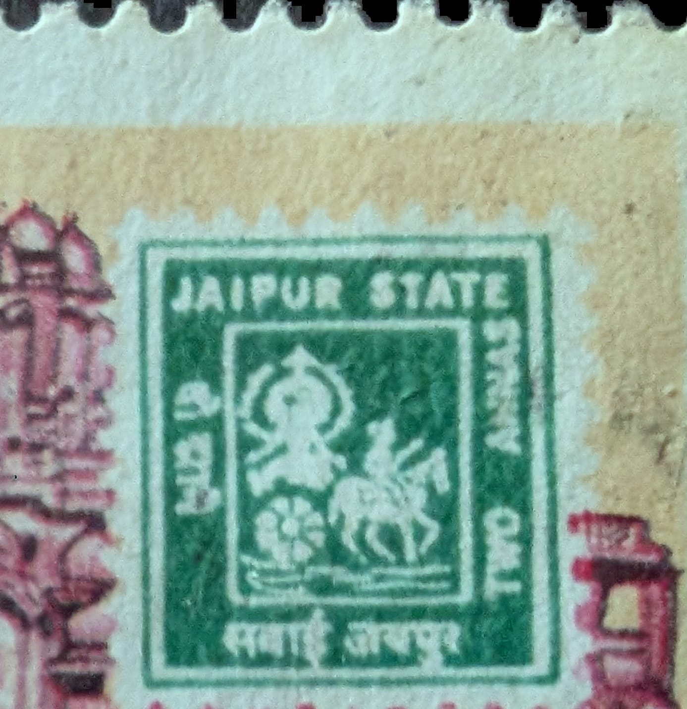 Macro of the green Jaipur State Two Annas stamp reproduced on the 1986 INPEX-86 issue, showing the Sun's Chariot device and JAIPUR STATE lettering