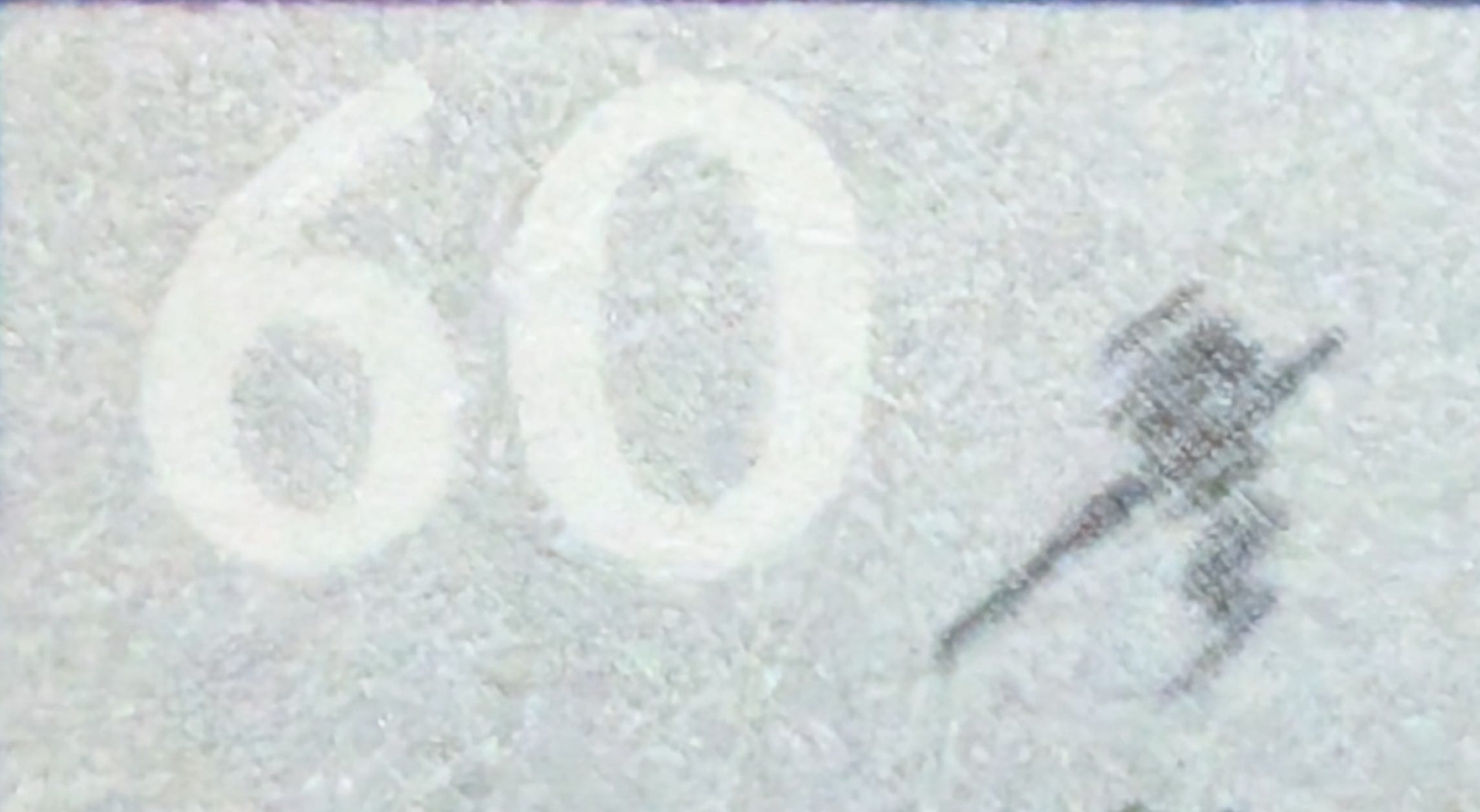 Macro of the top-left corner of the 1988 India stamp showing the pale 60-paise denomination beside the भारत India inscription