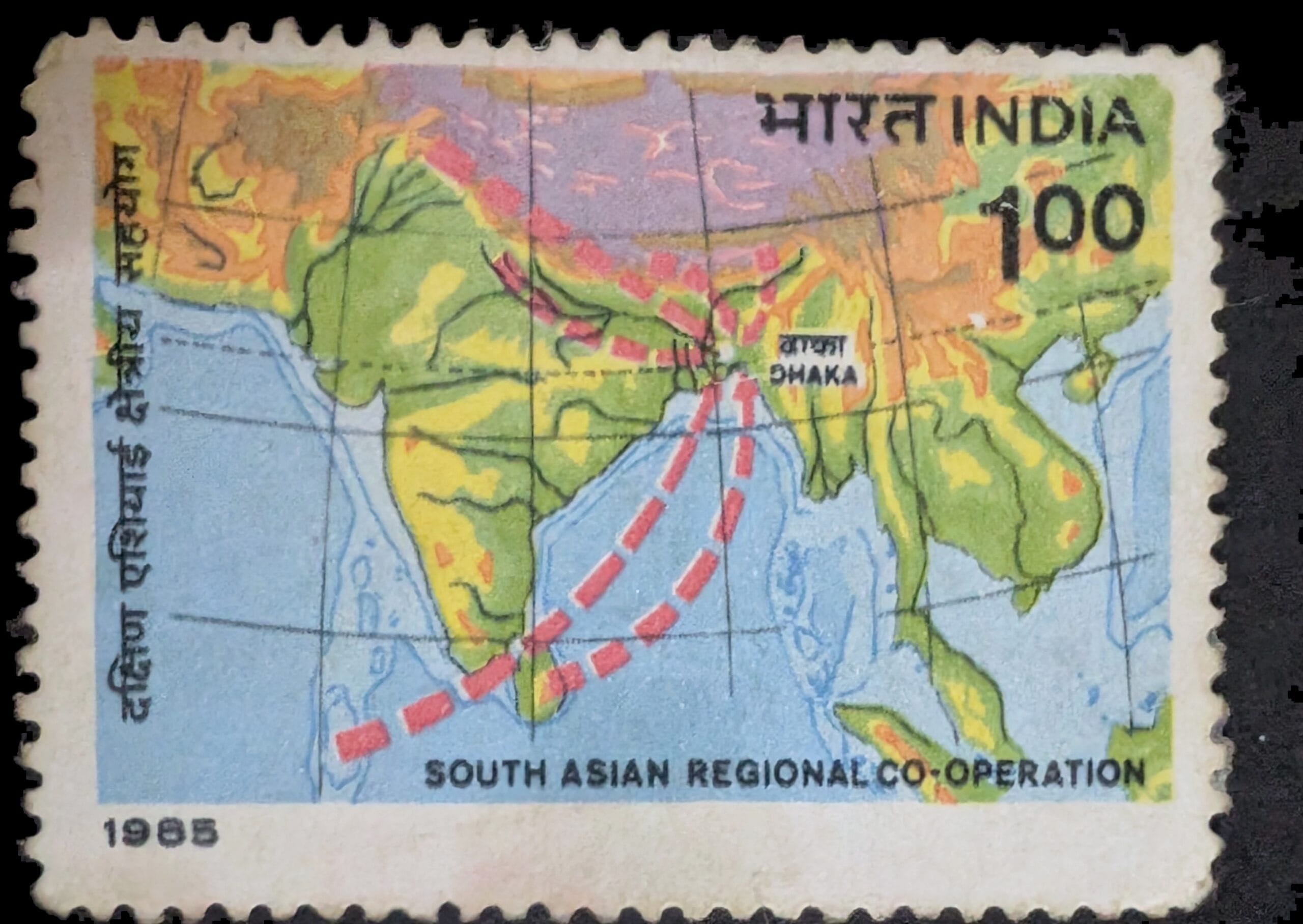 The complete 1985 India South Asian Regional Co-operation stamp, Re.1, showing a relief map of South Asia with red dashed routes meeting at Dhaka and the bilingual title band below