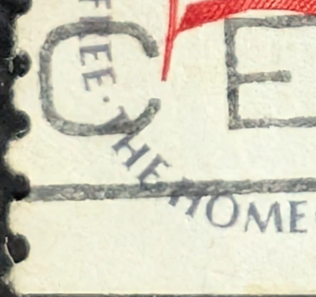 Macro of the bottom-left corner of the 1978 Fort McHenry Flag stamp where THE LAND OF THE FREE turns the corner into THE HOME OF THE BRAVE