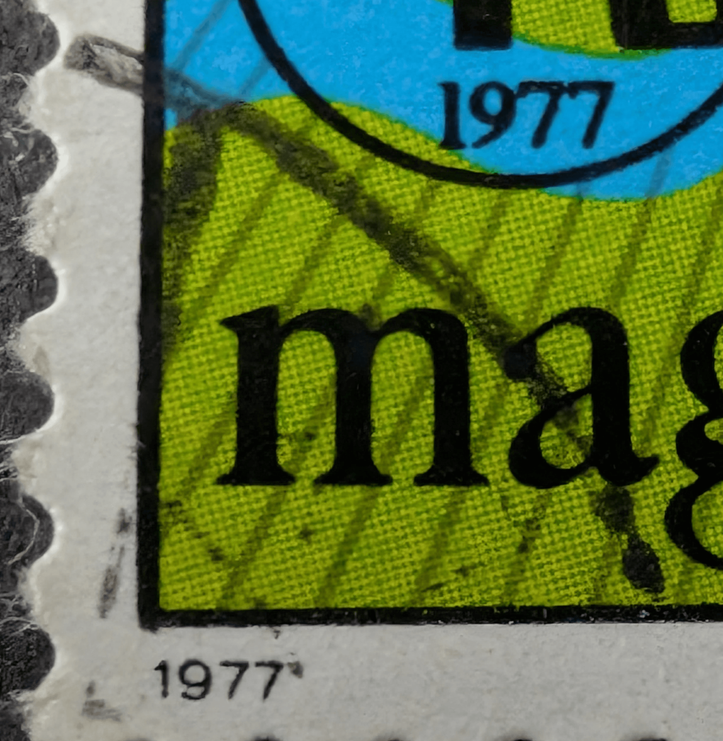 Macro of the postal cancellation stroke crossing the perforations at the lower left of the used 1977 World Rheumatism Year stamp