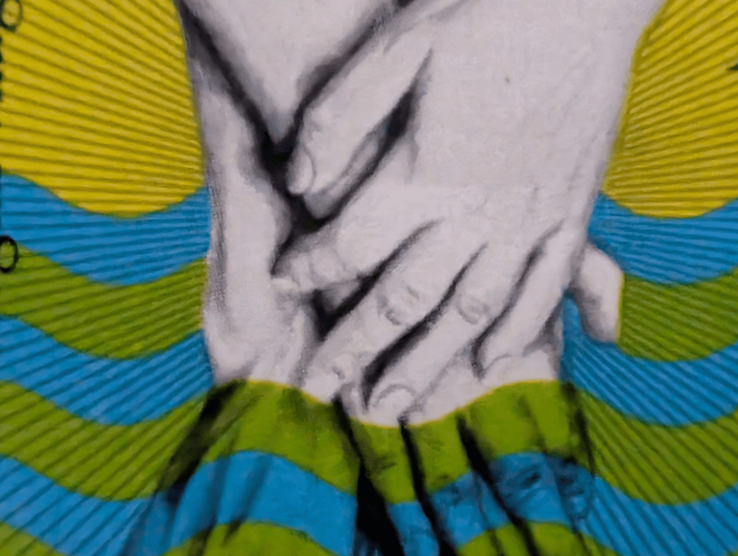 Macro of the clasped hands on the 1977 World Rheumatism Year stamp, where the crisp upper pair dissolves into a wave-banded ghost image below the horizon